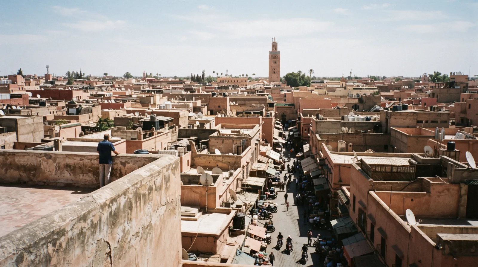 Hard vertical shadows in the medina lanes seen from a rooftop at midday, one day in Marrakech