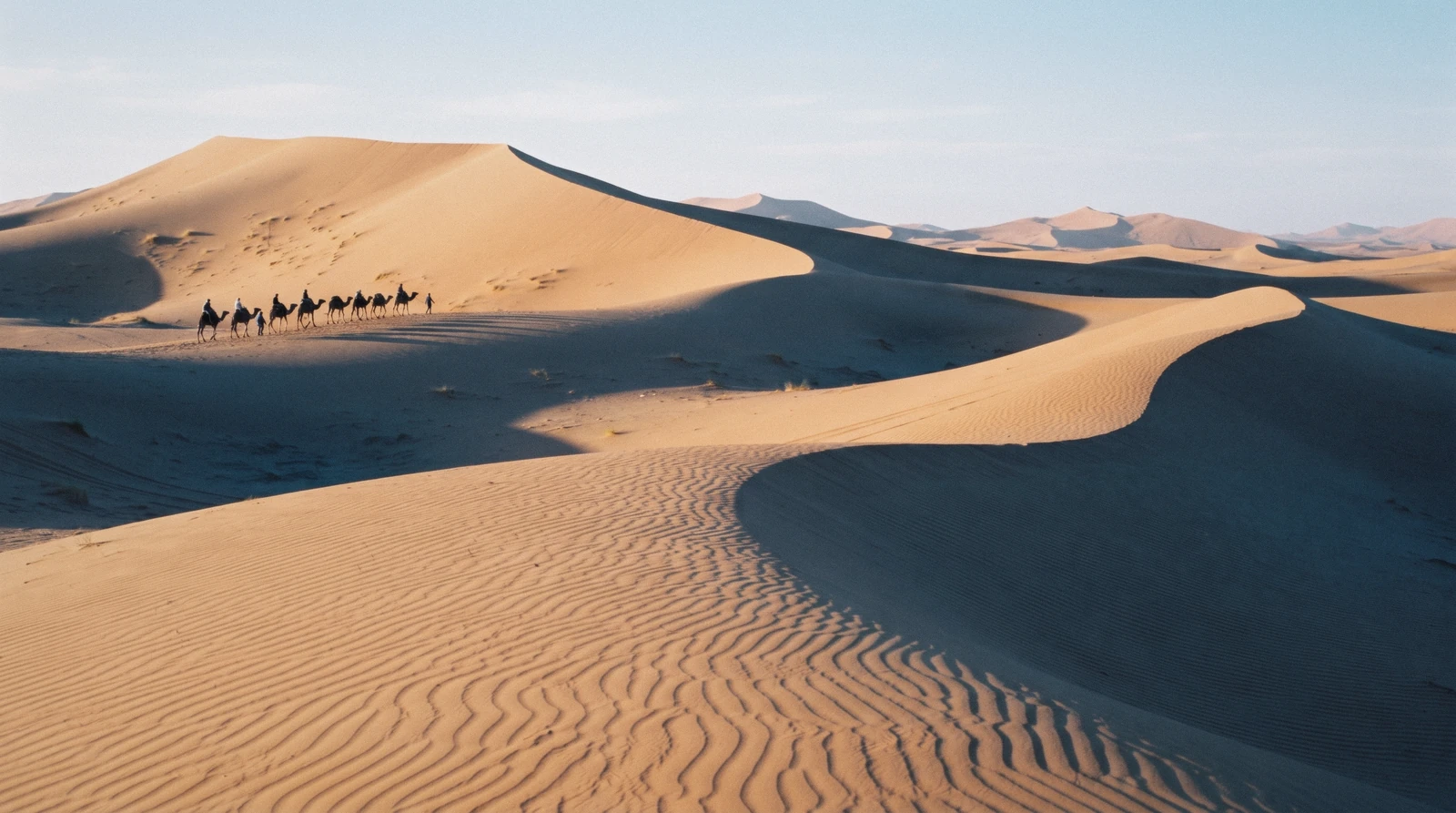 Wind-carved orange dunes of Erg Chebbi rising above flat desert at first light on a Merzouga desert tour from Marrakech