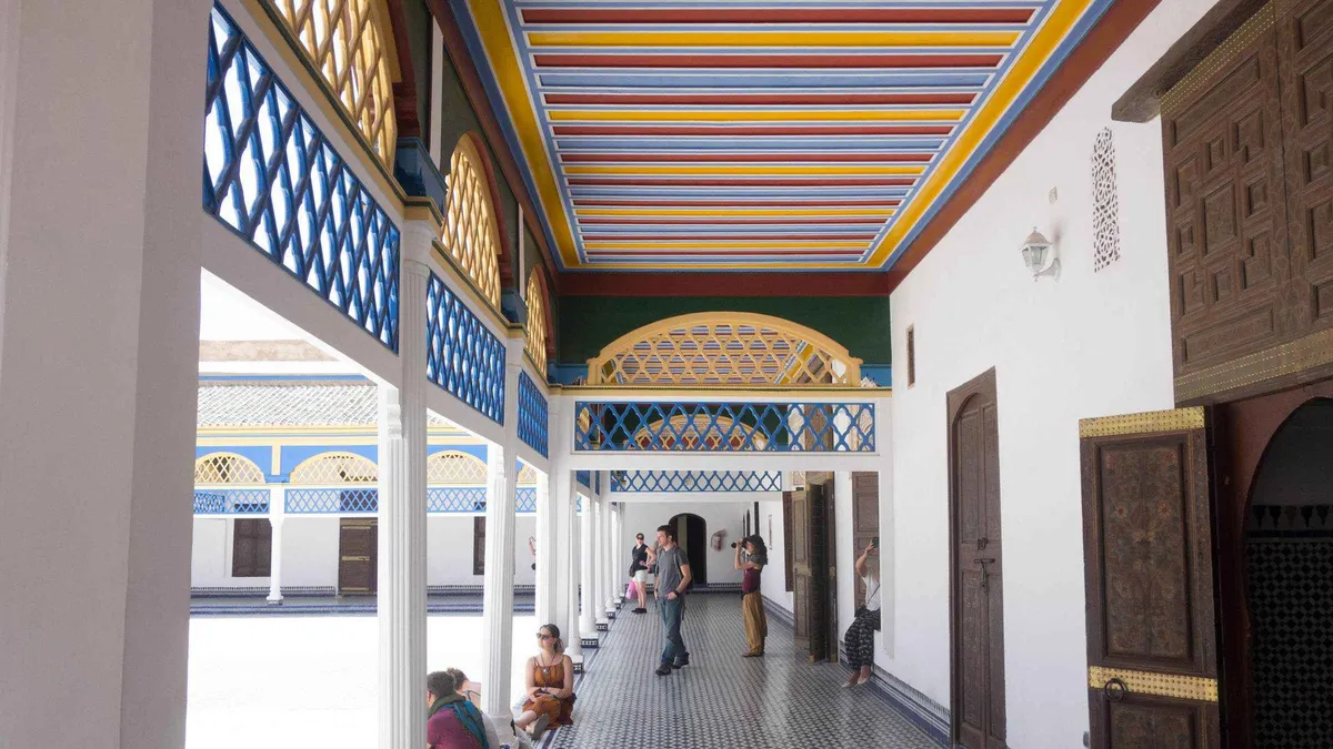 Students' cells and carved cedar galleries around the courtyard of Madrasa Ben Youssef on a Ben Youssef Madrasa and Bahia Palace tour in Marrakech