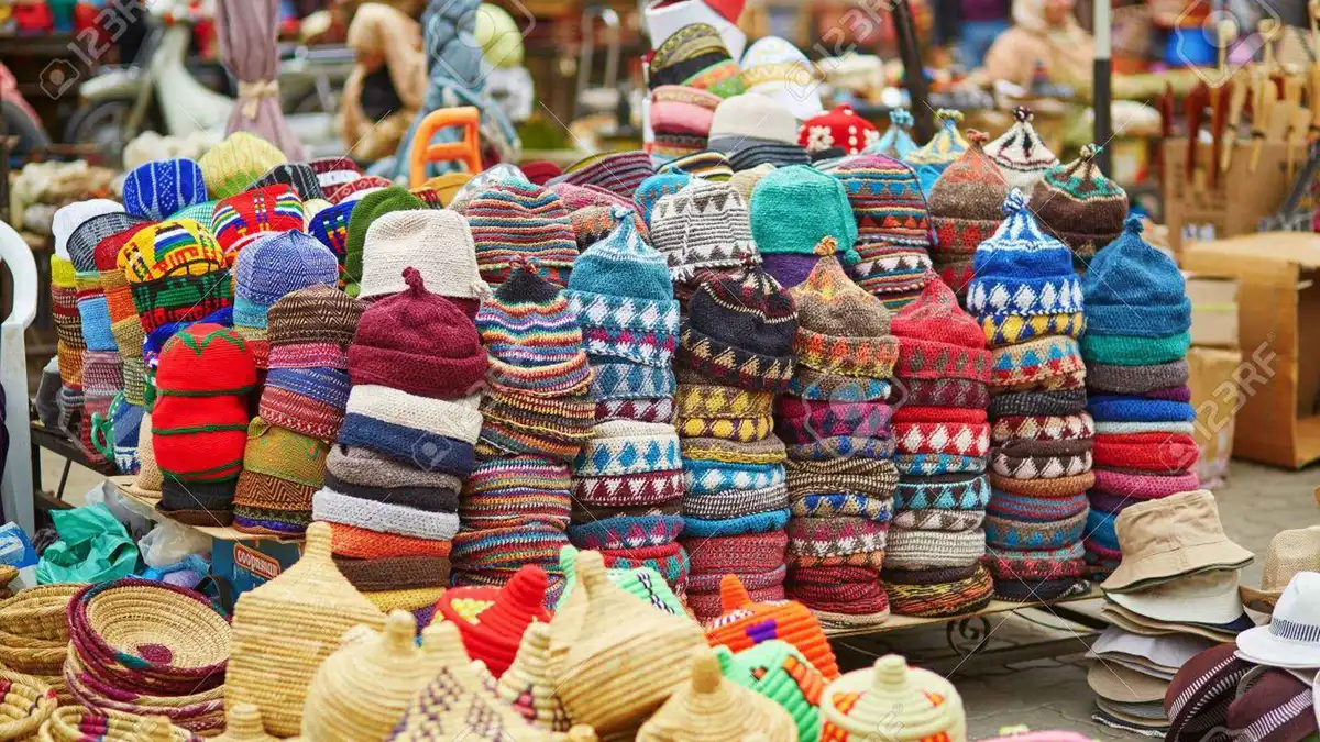 Stacks of leather babouches and lanterns in a souk stall on a guided souk shopping tour in Marrakech