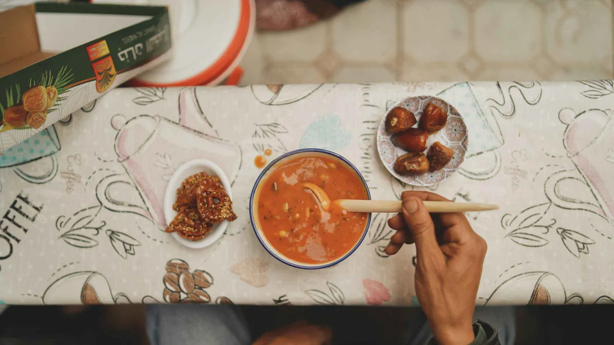 Tasting plates of msemen and olives at a medina stall on a Marrakech medina food tour