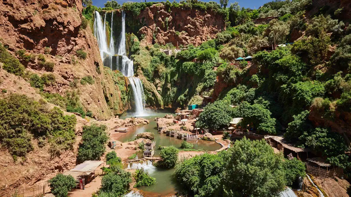 The Ouzoud waterfalls dropping in stages into the green pool below on an Ouzoud waterfalls day trip from Marrakech